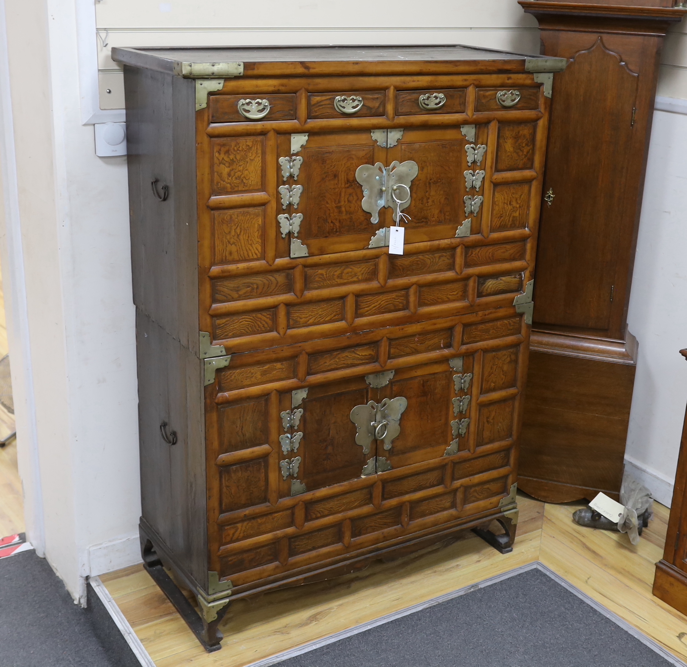 A Korean gilt metal mounted elm two part side cabinet, width 108cm, depth 46cm, height 149cm